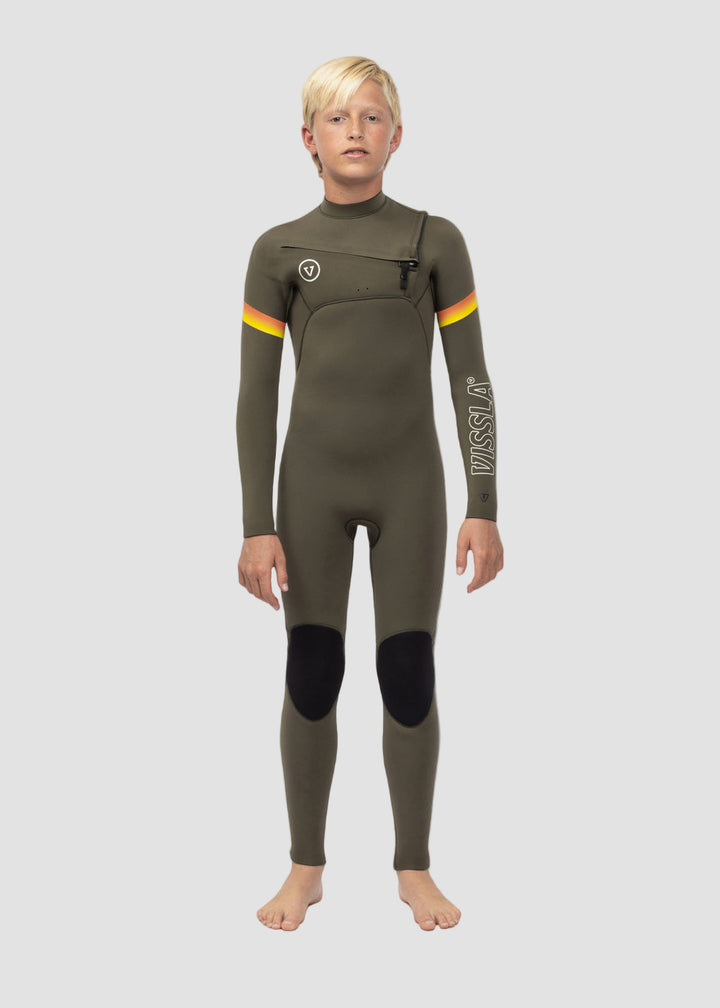 A boy standing straight facing forward wearing a full chest zip wetsuit which is green with black knee pads and yellow and orange accents.